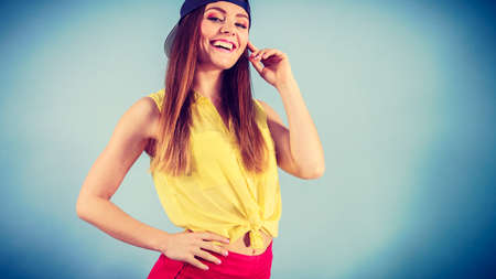 Holidays and vacation. Lovely trendy urban style girl in jeans cap. Portrait of long haired smiling attractive teenage woman.の写真素材