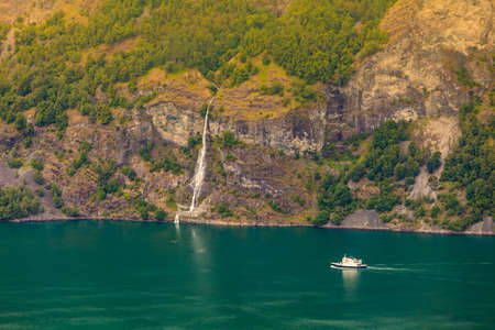 Tourism vacation and travel. Mountains landscape and large cruising ships on fjord in Norway Scandinavia.の写真素材