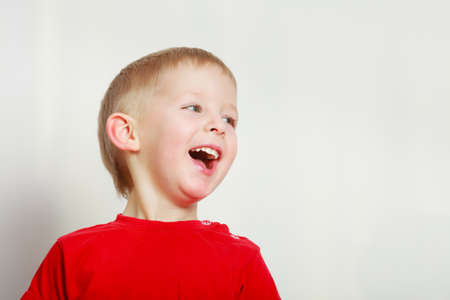 Face expressions, children concept. Portrait of happy kid boy making funny silly faces