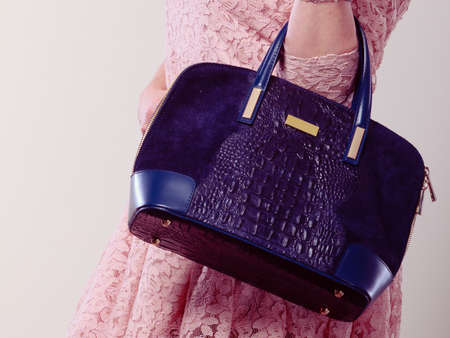 Shopping time. Part body of trendy woman wearing lovely lace pink dress. Lady with elegant black bag handbag.の写真素材