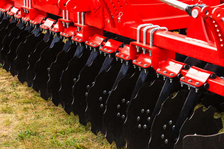 Agriculture equipment concept. Detailed closeup of disc harrow, agricultural machinery. Outdoor shot