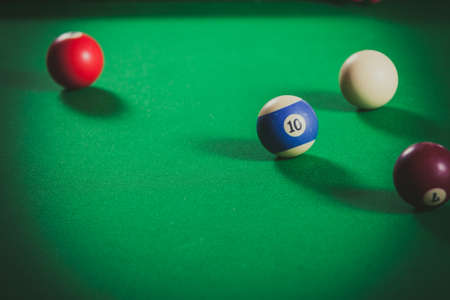 Billiard cue balls on green table. Pool game