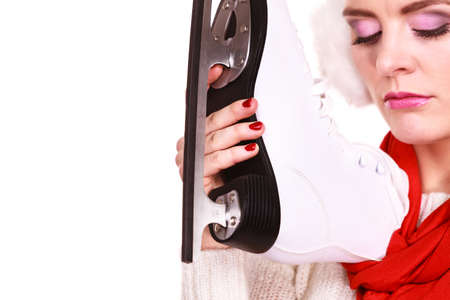 Pensive sad young woman with ice skates on whiteの写真素材