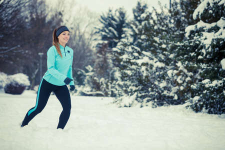 Girl exercising in park. Winter sports, outdoor fitness, fashion, nature workout, health concept.