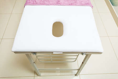 Profession workplace equipment concept. Professional clean bed in beautician spa salon ready for next client.の写真素材