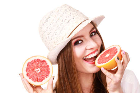 Woman attractive long hair girl colorful eyes makeup holding two halfs of grapefruit citrus fruit in hands. Healthy diet food. Summer holidays fun concept, on whiteの写真素材