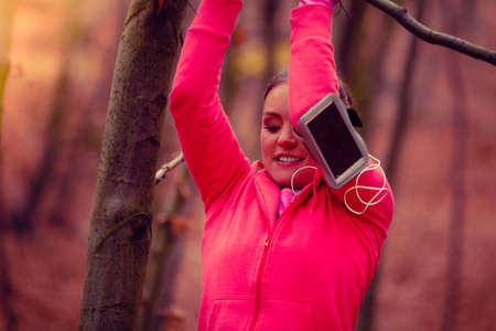 Healthy and sporty lifestyle. Young fit girl doing exercises on fresh air outdoor. Woman do fitness...