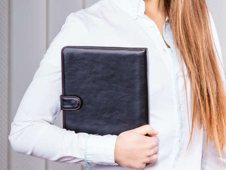 Career business work in office. Young woman in formal wear hold case with files documents paperwork.