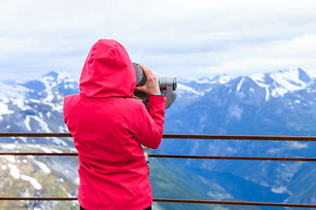 Tourism vacation and travel. Woman looking through sightseeing binoculars tourist telescope,...