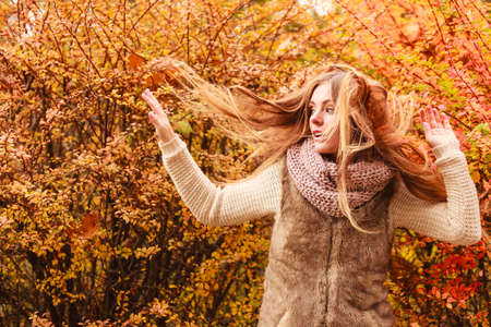 People moving outdoors concept. Shot of movement in the park. Beautiful and stylish lady wearing fashionable clothes. Woman has long hair.の写真素材
