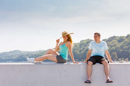 Relationship goals, outdoor relaxation, love and friendship concept. Man and woman sitting together outside hugging, having date.の写真素材