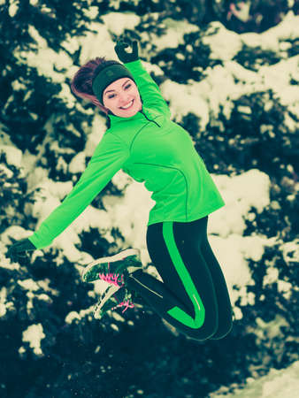 sports activity in winter time healthy lifestyle concept fit woman athlete girl training outdoor wearing warm sporty clothes in cold day snow weather toned imageの写真素材