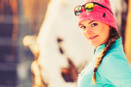 Fit girl posing in park. Showing beauty in winter enviroment. Health nature fitness fashion concept.