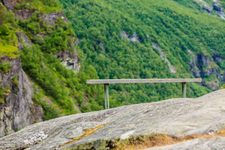 Tourism vacation and travel. Serene mountains landscape with rest place lonely bench, Norway Europe.
