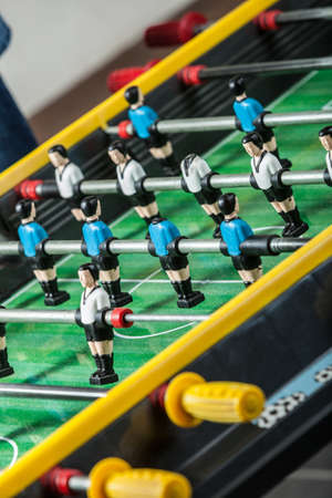 Entertaining games, fun play entertainment concept. Closeup of soccer table football players.
