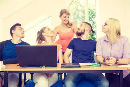 Education concept. Highschool students having fun during a break in classroom interiorの写真素材