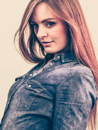 Fashion, beauty, people, jeans concept. Beautiful model posing in the studio. Young lady wearing denim shirt.の写真素材
