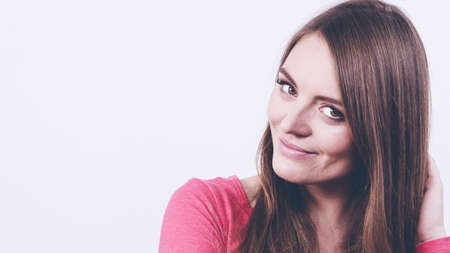 Happy girl in pink clothing. Young cheerful woman portrait.  Fashion beauty coiffure lifestyle concept.の写真素材