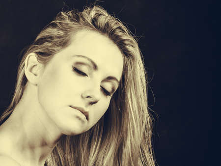 Elegance, feminity, lady beauty concept. Portrait of beautiful dreaming elegant woman with her eyes closed in sepiaの写真素材