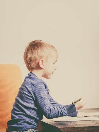 Creative hobby, kids passion concept. Kid playing, drawing pictures on paperの写真素材