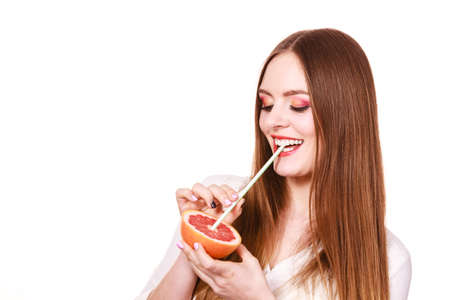 woman attractive long hair girl colorful eyes makeup holding grapefruit citrus drinking juice from fruit healthy diet food summer vacation holidays concept copy space for textの写真素材