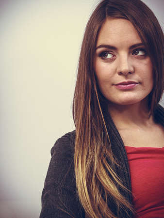 Disapproving young female. Disbelieving long brown haired woman. Glamorous lady.の写真素材