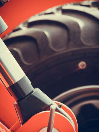 Agriculture equipment concept. Detailed closeup agricultural machinery, big wheels with tires. Outdoor shotの写真素材
