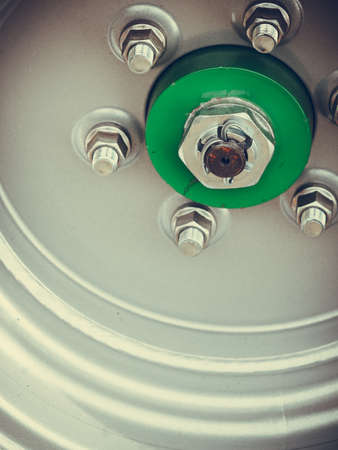 Agricultural industrial equipment details concept. Screws on wheel rim, big tractor vehicleの写真素材