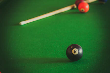 Billiard balls and cue stick on green table. Pool gameの写真素材
