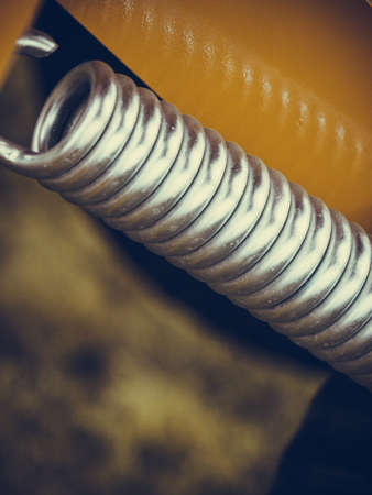 Industrial details, mechanical objects and tools concept. Springs on steel big machinery closeupの写真素材