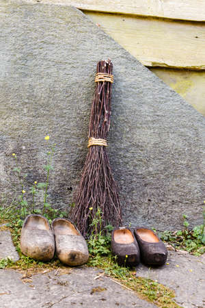 Regional tradition and culture, handmade concept. Wooden dutch shoes, traditional clogs footwear standing in rowの写真素材