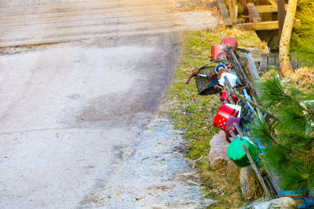 Oldfashioned vintage village details design concept. Old wooden fence with pots and wicker baskets on it.の写真素材