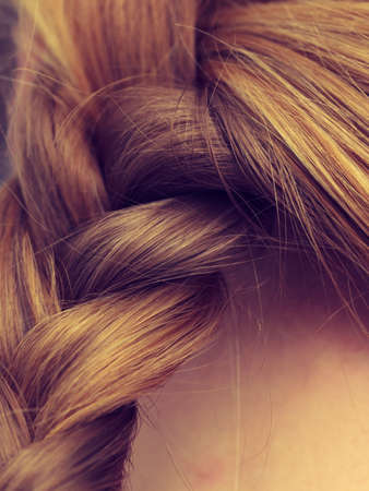 Fancy trendy blond hairstyle ideas concept. Closeup of woman blonde braided hair.の写真素材