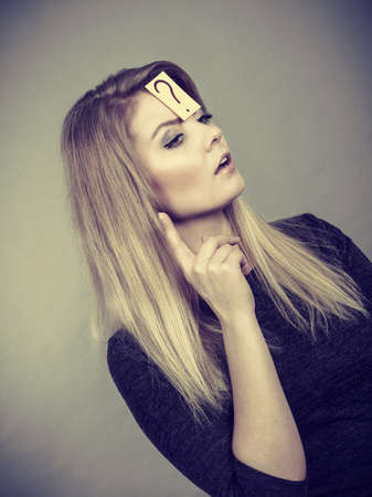 Intellectual expressions, being focused concept. Closeup of attractive woman having question mark on...
