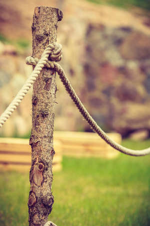 Garden design concept. Old fashioned fence made of sticks and cord, outdoor shot.の写真素材