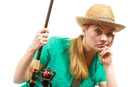 Fishery, spinning equipment, angling sport and activity concept. Bored woman with fishing rod, waiting for fish to hunt.の写真素材