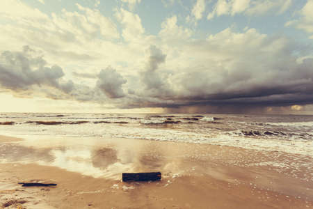 Amazing colorful sunset over evening sea horizon, clouds sky and sandy beach. Tranquil scene. Natural background. Landscape.の写真素材