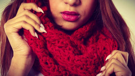 Fashion, snowy time people concept. Woman with red winter clothing.Young model wearing warm scarfの写真素材