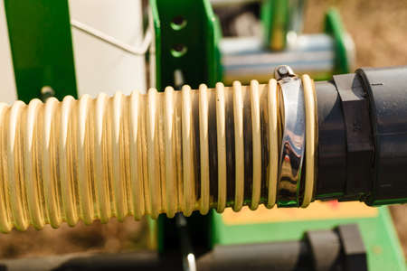 Machines, production concept. Detailed closeup of flexible plastic hose, pipes.