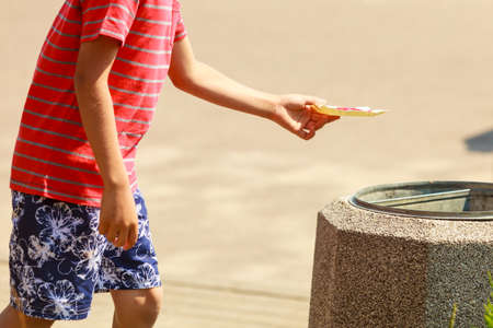Sweets and candy food. Little boy kid with sweet meal outdoor. Male child enjoying eating his dessert outside in sunny weather.の写真素材