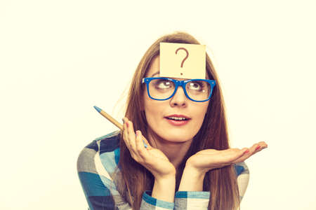 Thinking woman with big nerdy eyeglasses and question mark on forehead, on beige bright. Creating...