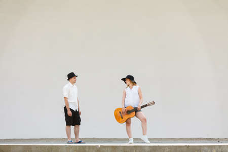 Relationship goals concept. Couple on romantic date. Woman playing guitar, man standing next to her