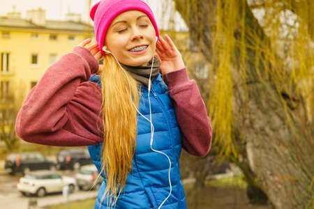 Sports and activities in cold time. Slim fit fitness woman outdoor. Athlete teen girl wearing warm...