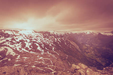 Tourism vacation and travel. Fantastic view from the Dalsnibba Plateau viewpoint on Geirangerfjord and mountains landscape with road winding through hills, Norway Scandinavia.の写真素材