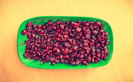 Vitamins, food good for kidneys. Plate bowl full of red dried cranberries