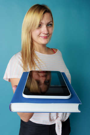 Modern education, devices for reading books, learning choice concept. Blonde woman holding book and...