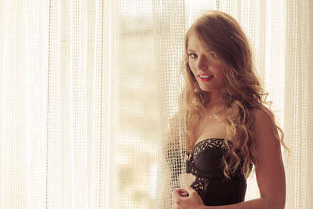 Fashion, people, clothing concept. Smiling sexy girl with a corset. Lady with night clothes.の写真素材