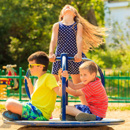Joyful active childhood. Playful kids playing on playground. Children having fun in summer. Young tourists spending actively time.の写真素材