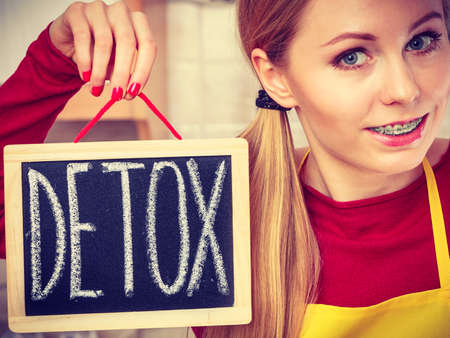 Dieting and detoxing, weight loss concept. Happy woman holding board with detox signの写真素材