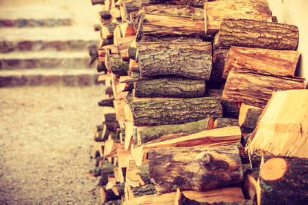 Firewood, home heating concept. Pile of cutted wood standing outside, outdoor shot.の写真素材